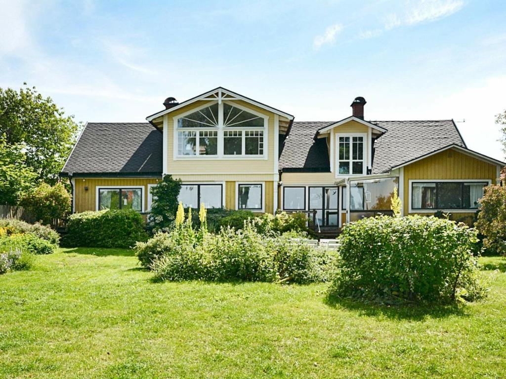 a large yellow house with a roof at Five-Bedroom Holiday home in Mörbylånga in Mörbylånga
