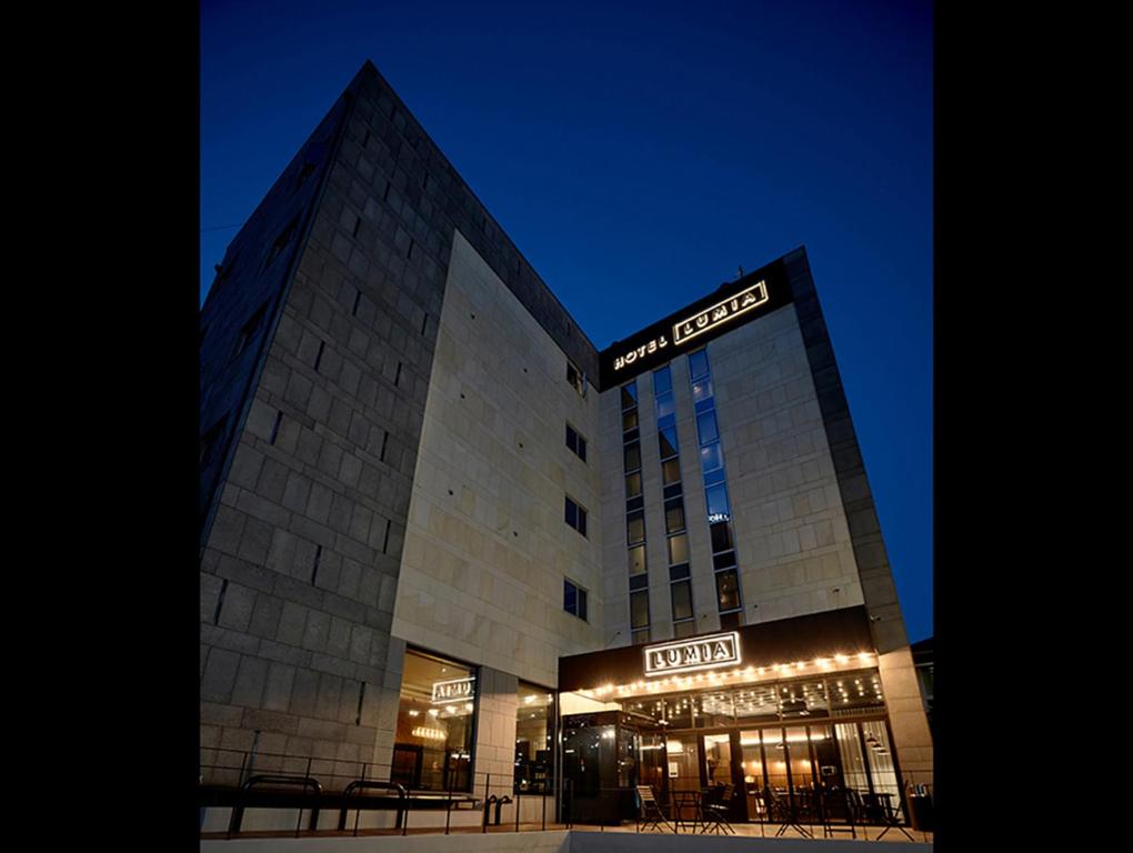 a building with a sign on the front of it at Hotel Lumia Myeongdong in Seoul