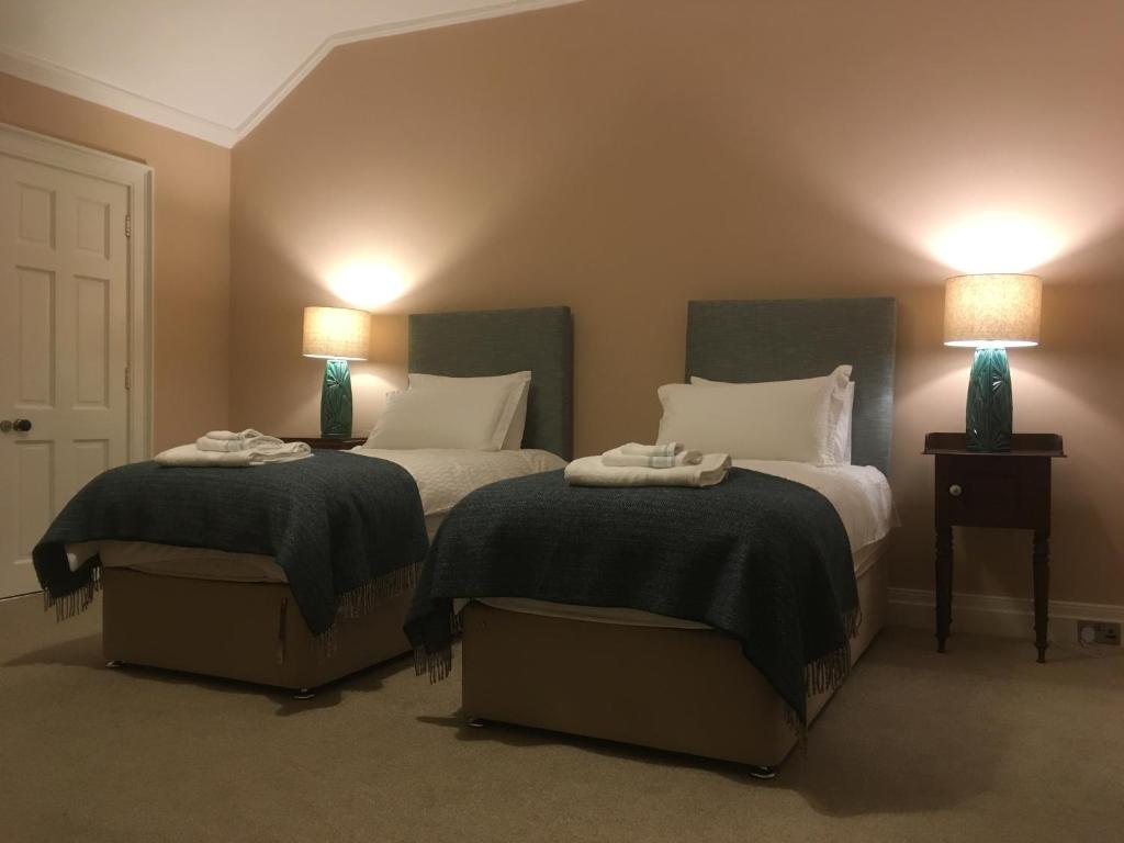 two beds in a room with two lamps on them at Number 6 Narrow Water Castle in Warrenpoint