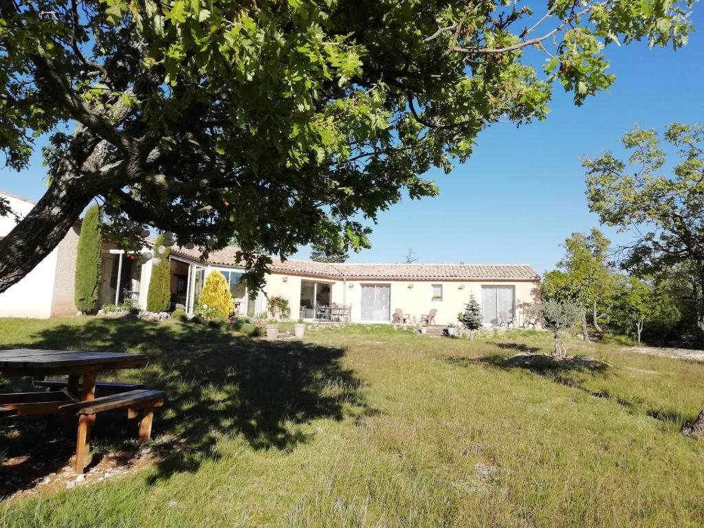 uma casa com uma mesa de piquenique no quintal em LA MAGUETTE em Sault-de-Vaucluse