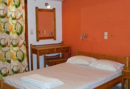 Postel nebo postele na pokoji v ubytování Mavroforos Hotel