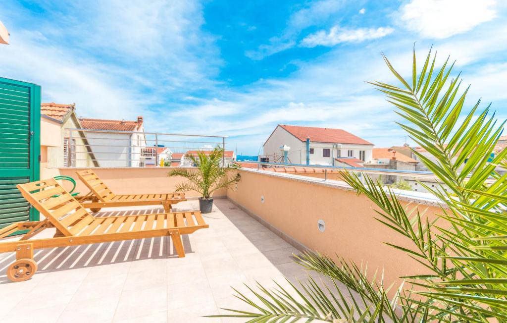 a balcony with a bench and a view of the ocean at Apartments Villa-Ines Center in Vodice