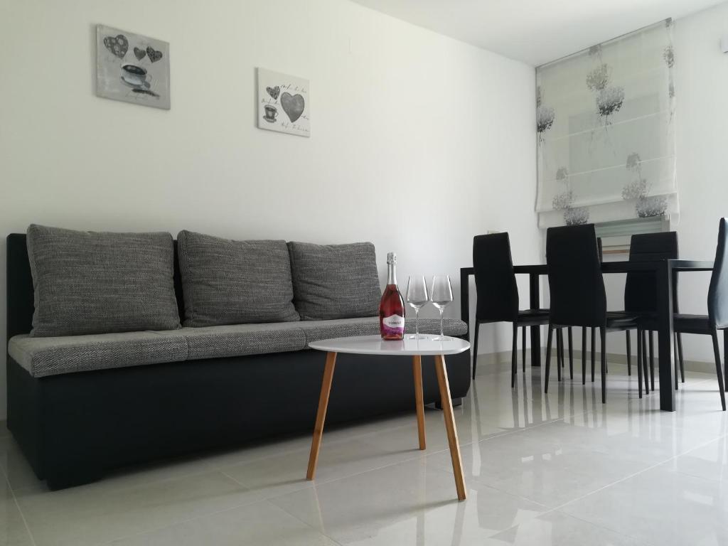a living room with a couch and a table at Apartman Ana in Porat