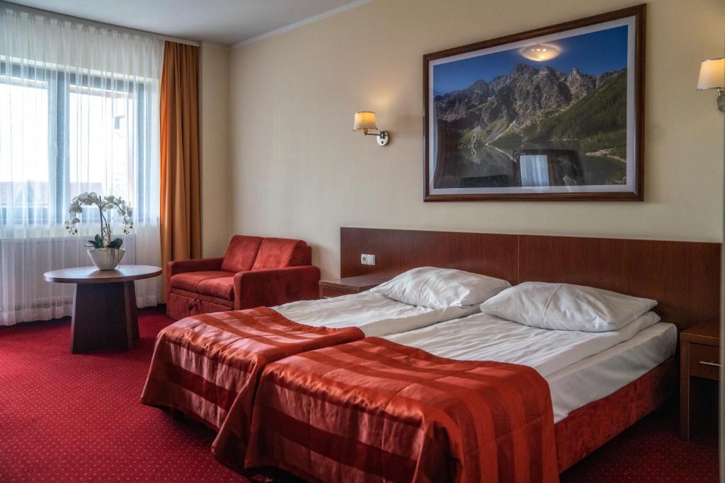 Posteľ alebo postele v izbe v ubytovaní Hotel Tatra
