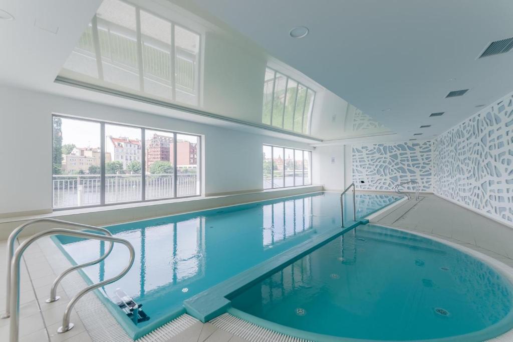 a large swimming pool in a building at Zefiro Chmielna in Gdańsk