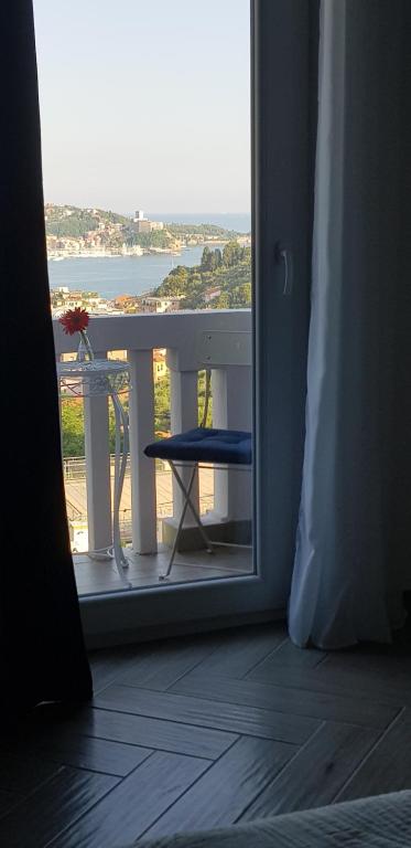 a room with a view of a balcony with a table at La Maison Golfo dei Poeti in Lerici