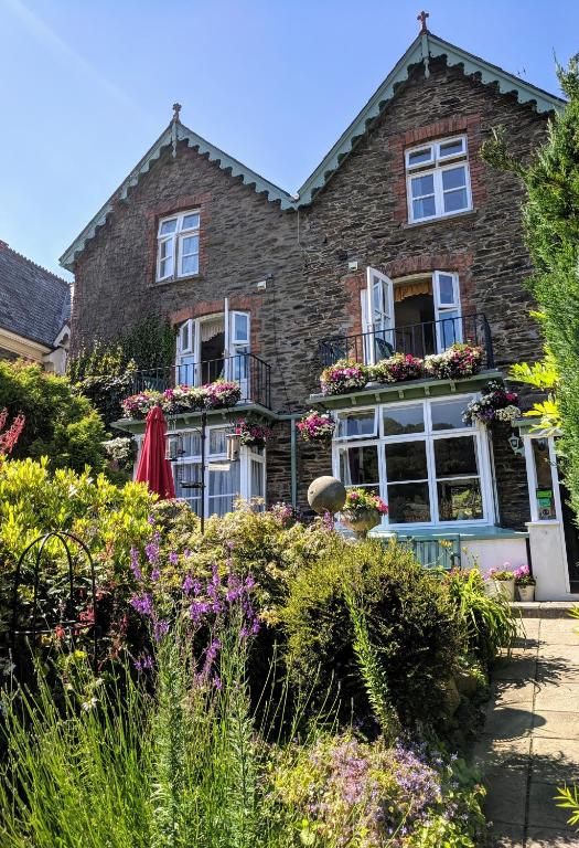 a house with flowers in front of it at Lee House in Lynton