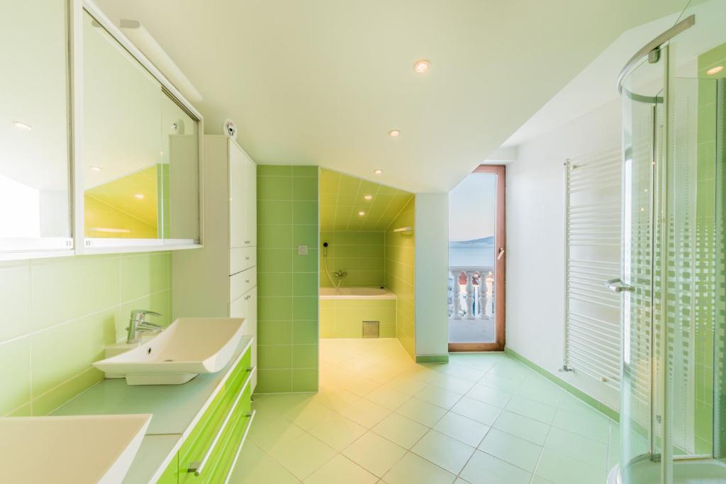 a bathroom with a sink and a shower at Apartments Petrić in Seget Vranjica