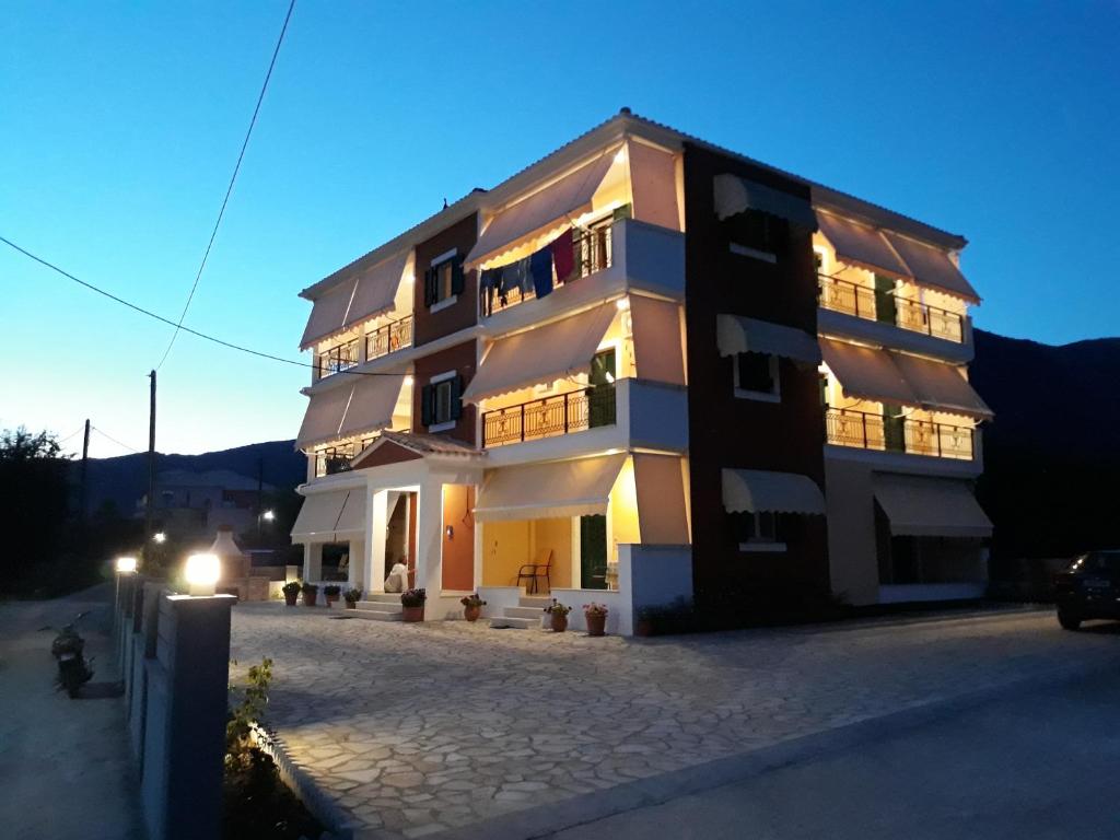 a large building with its lights on at Vaso apartments in Nydri