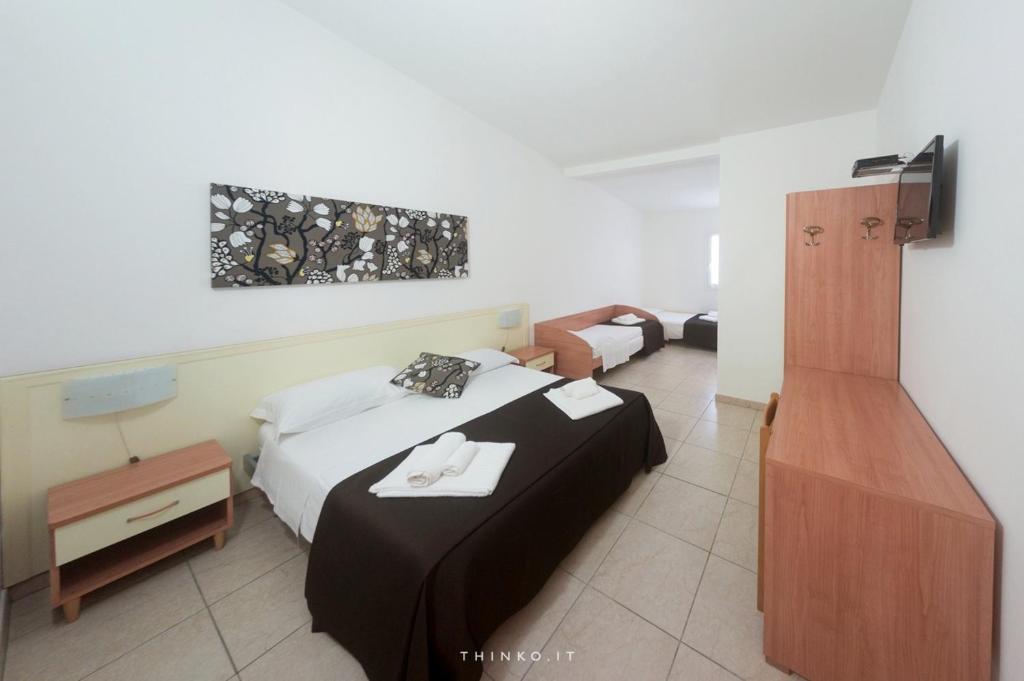 Postel nebo postele na pokoji v ubytování Hotel Universo