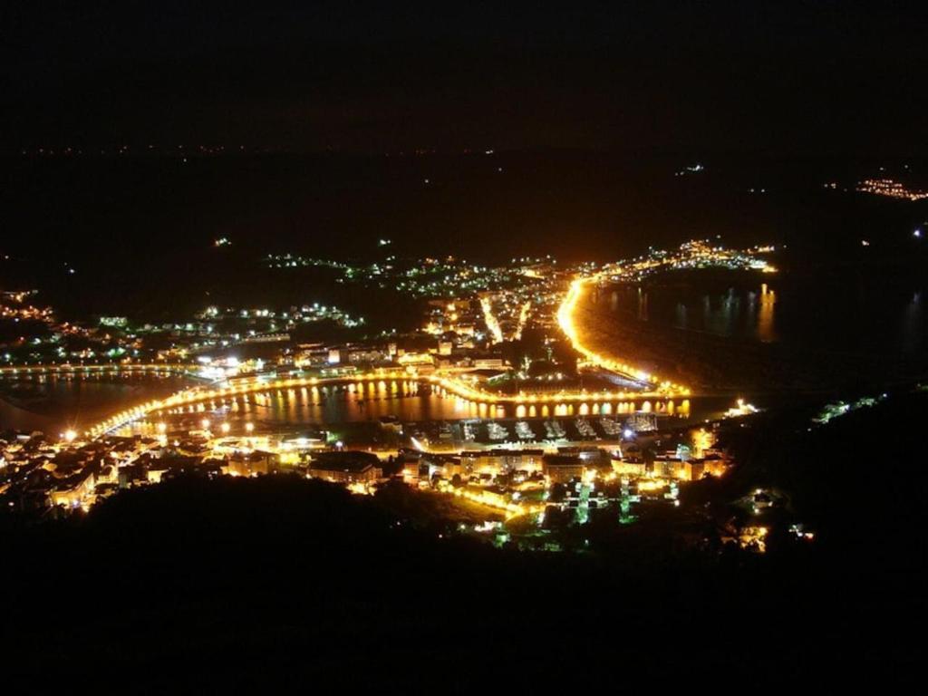 a view of a city at night with a bridge at Apartamento en 1ª línea de la Playa de Covas - Viveiro (Lugo) in Viveiro
