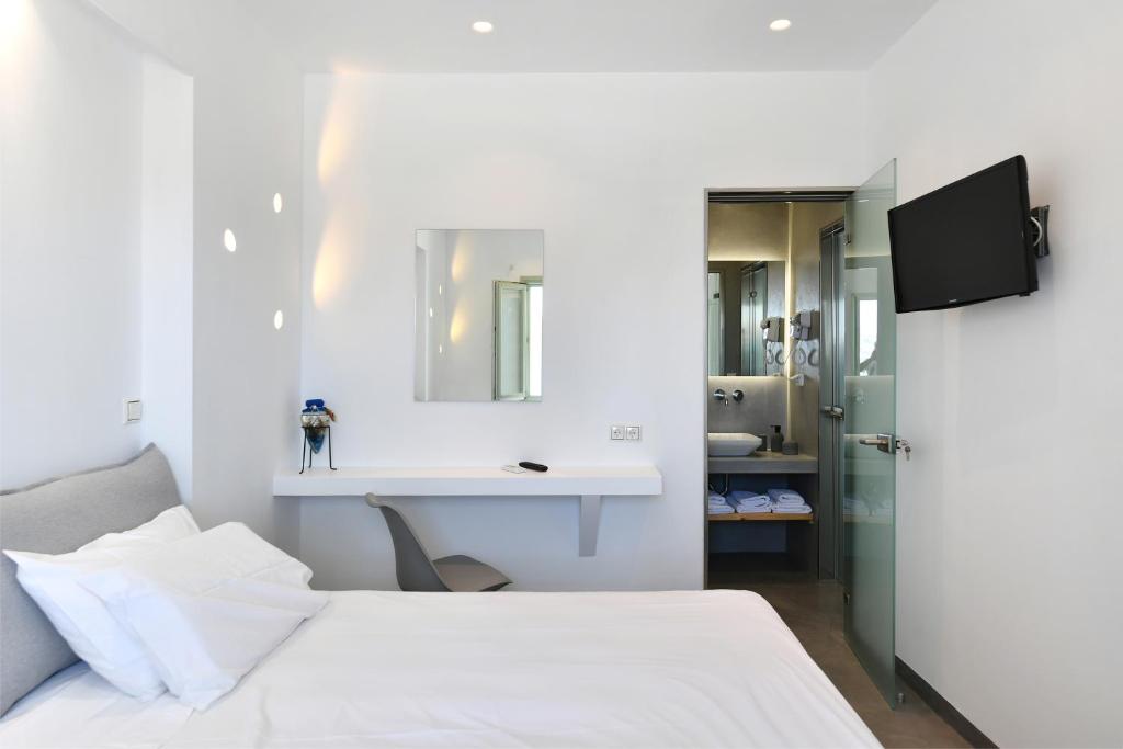 A bed or beds in a room at Lorenzo Studios and Suites Paros