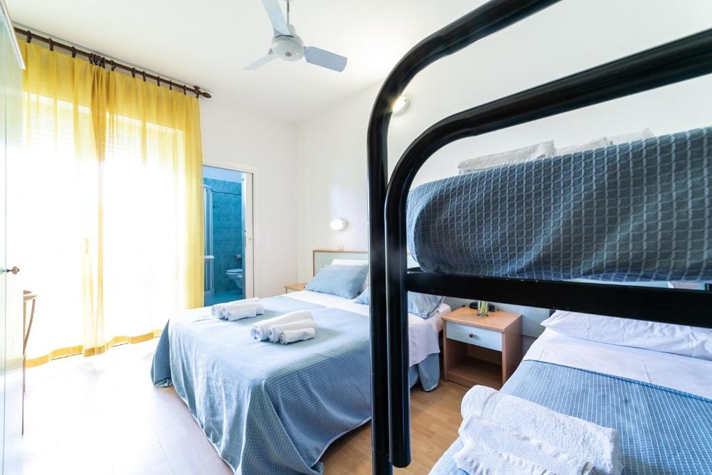 Postel nebo postele na pokoji v ubytování Hotel Augusta