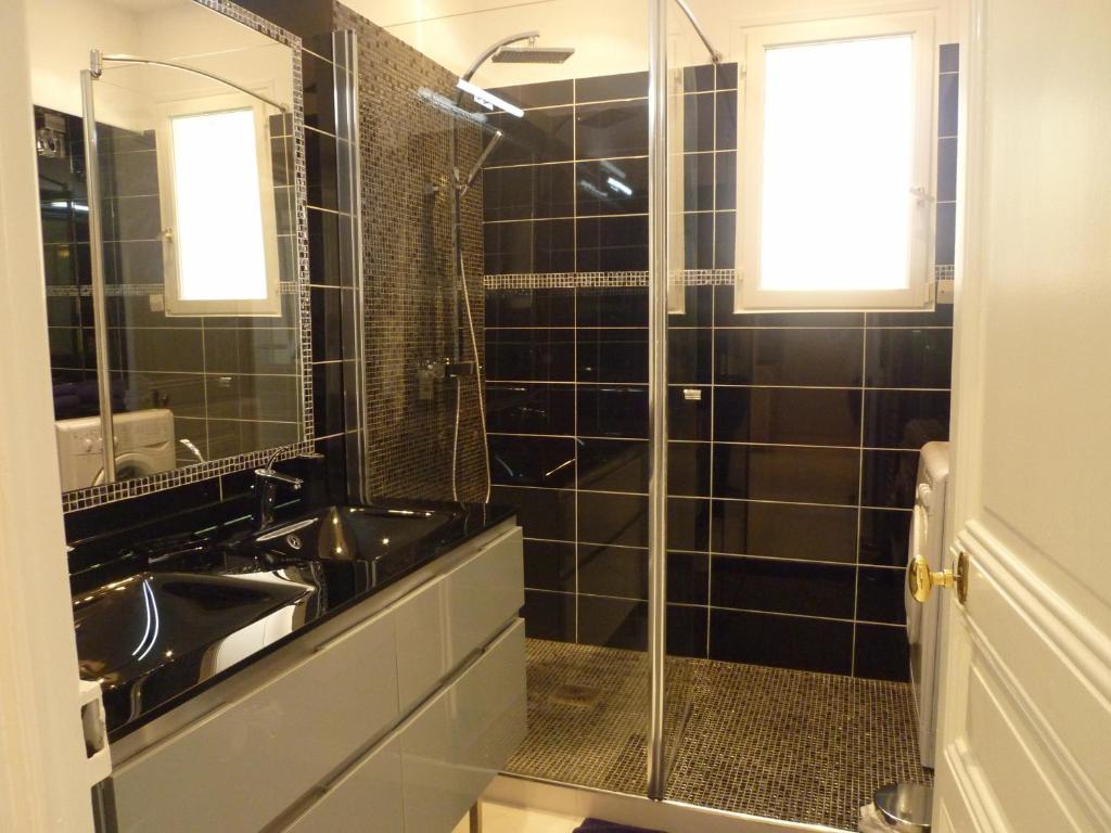 a black tiled bathroom with a sink and a shower at Palais Augusta- CAT3615- 2Bedrooms in Cannes
