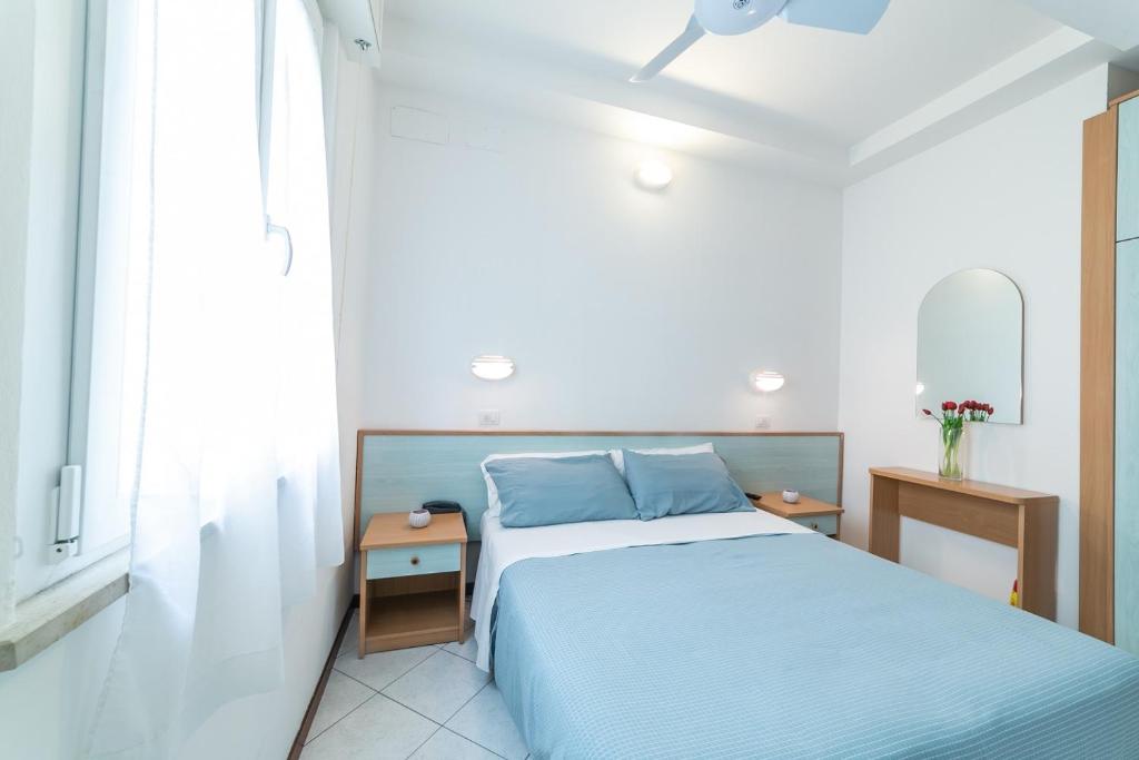 Postel nebo postele na pokoji v ubytování Hotel Augusta