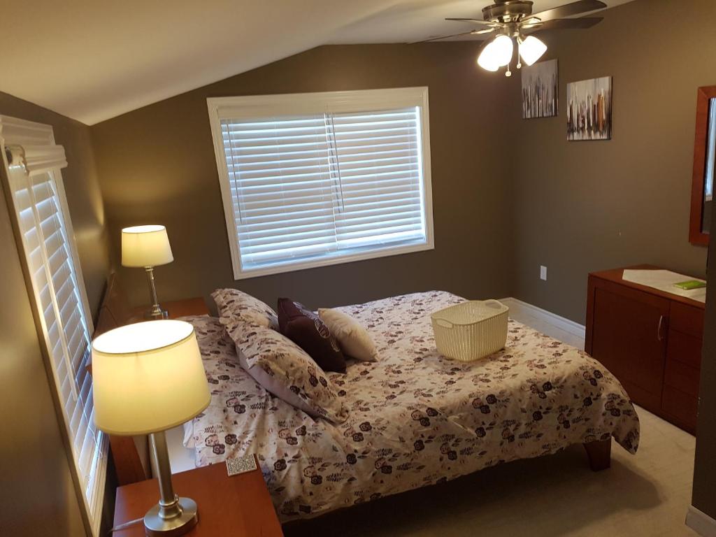 a bedroom with a bed with pillows and a window at Small Town Bound Inn in Montague