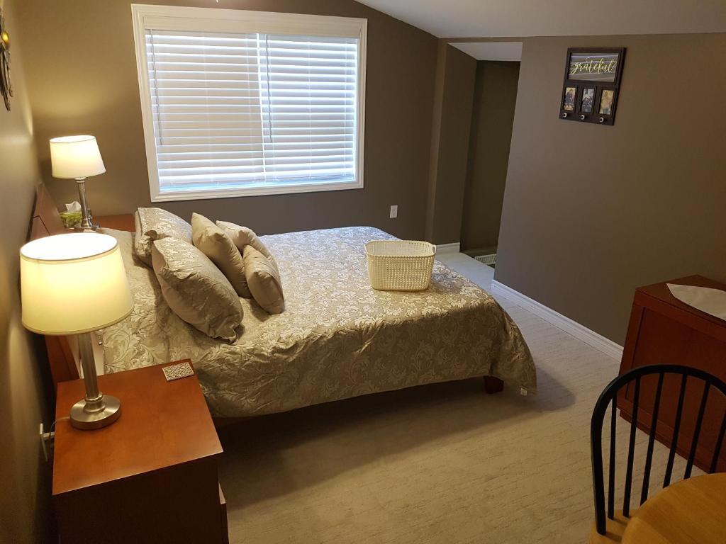 a bedroom with a bed with pillows and a window at Small Town Bound Inn in Montague