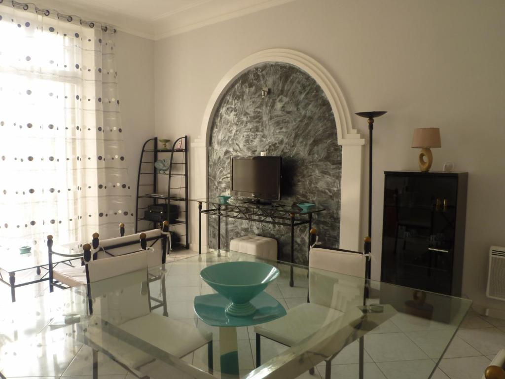 a living room with a glass table and chairs at Palais Augusta- CAT3615- 2Bedrooms in Cannes