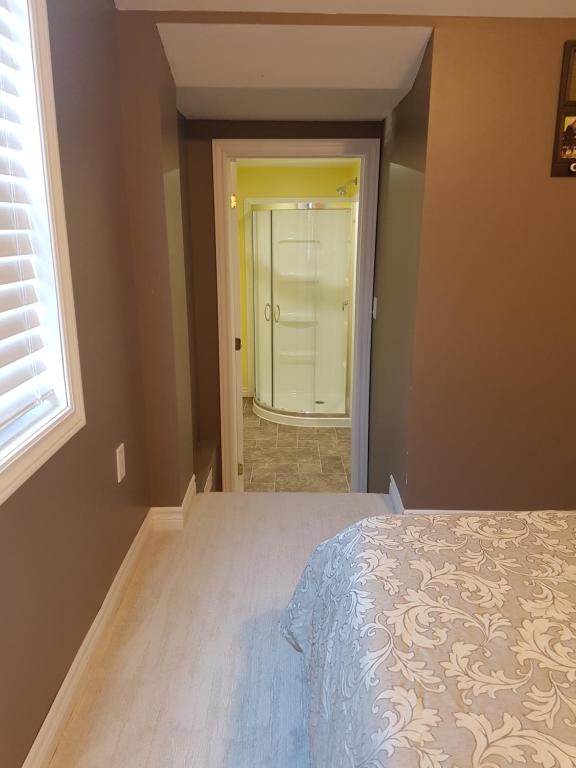 a bedroom with a bed and a door to a bathroom at Small Town Bound Inn in Montague