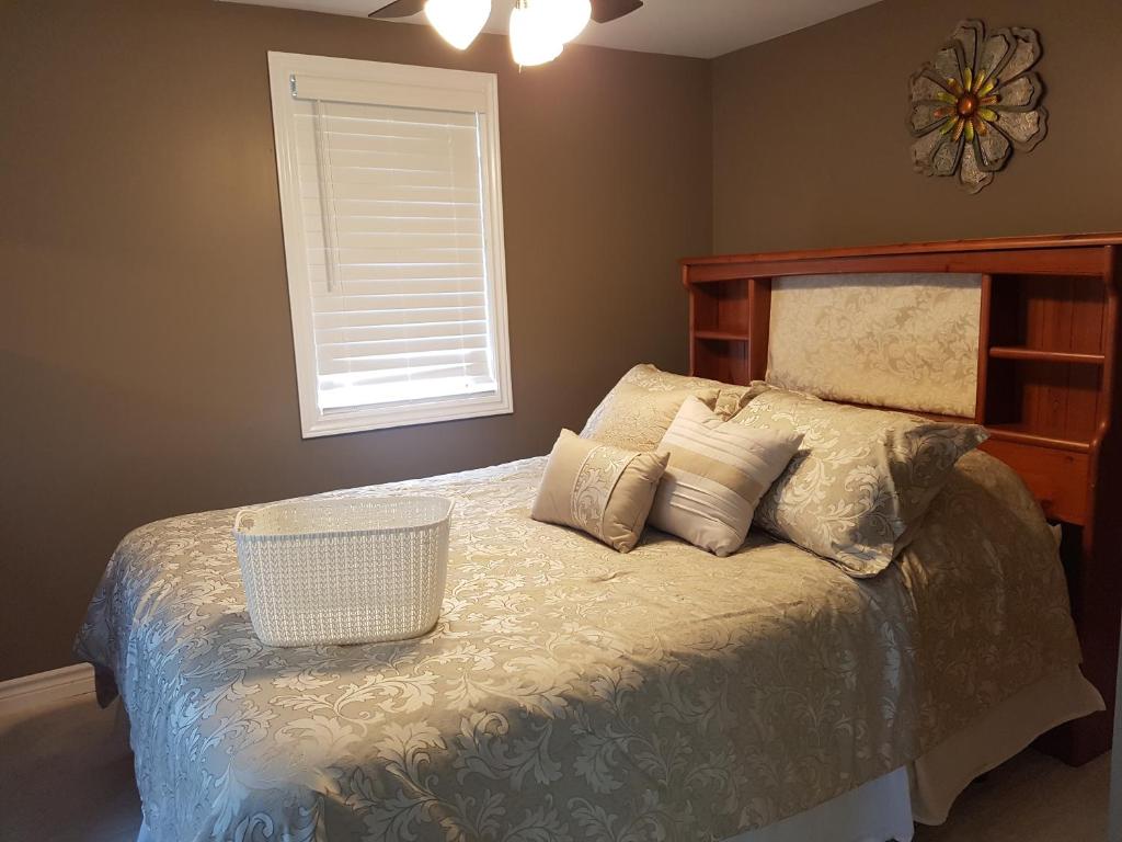 a bedroom with a bed with pillows and a window at Small Town Bound Inn in Montague