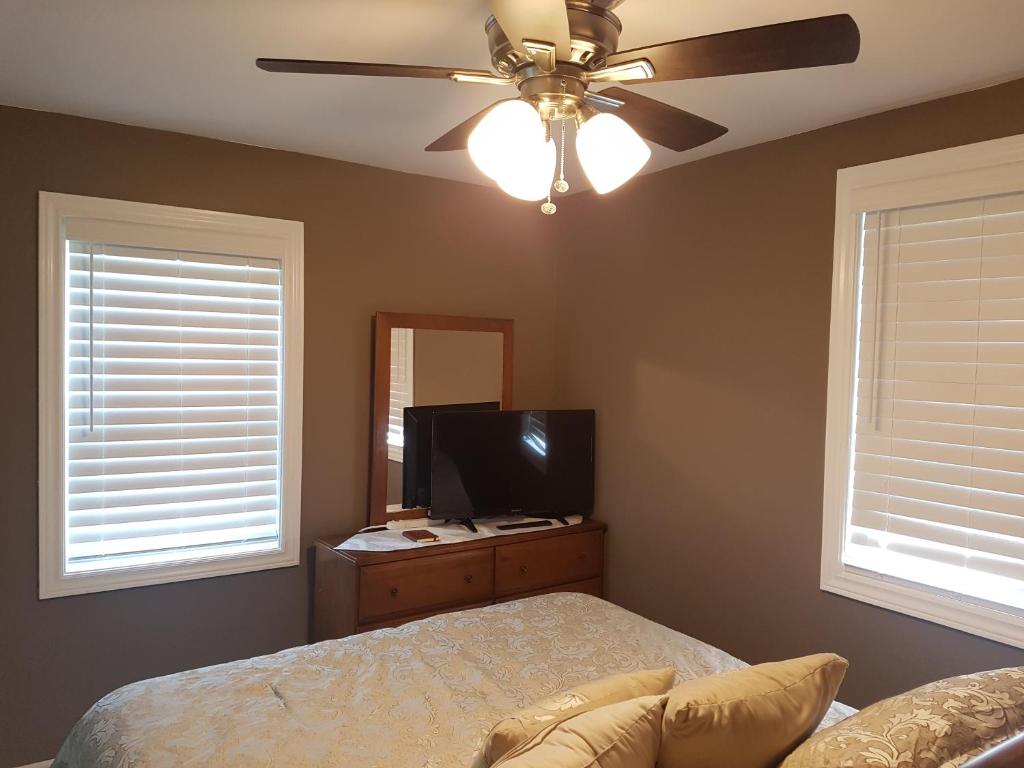 a bedroom with a bed and a flat screen tv at Small Town Bound Inn in Montague