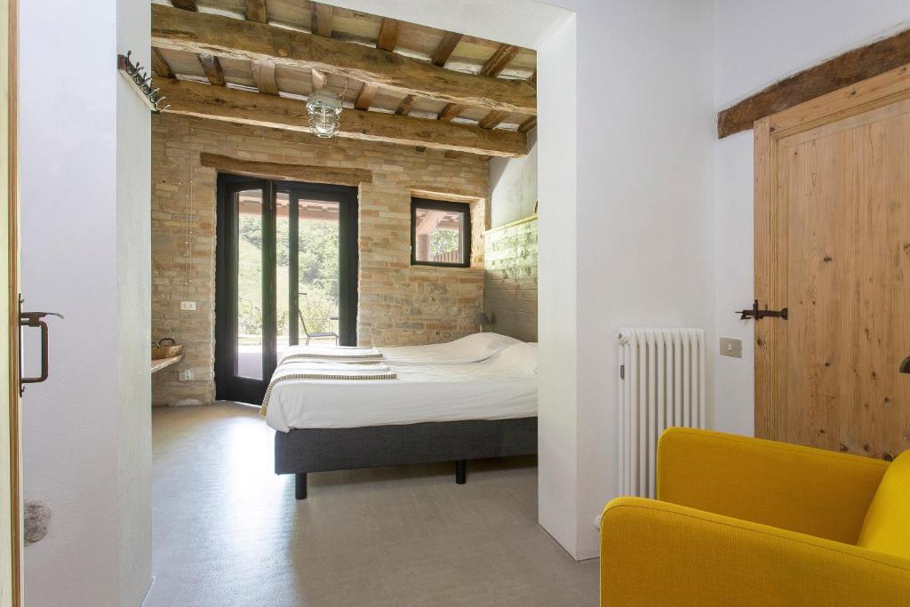 Postel nebo postele na pokoji v ubytování Agriturismo Unico Senso