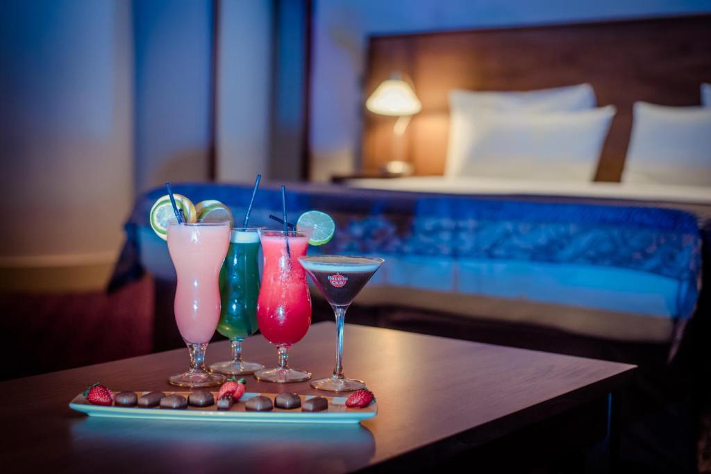 three cocktails on a table in a hotel room at Osprey Hotel in Naas