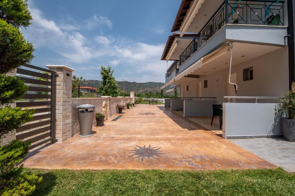 an empty patio in front of a building at A Ponte Studios & Apartments in Sykia Chalkidikis