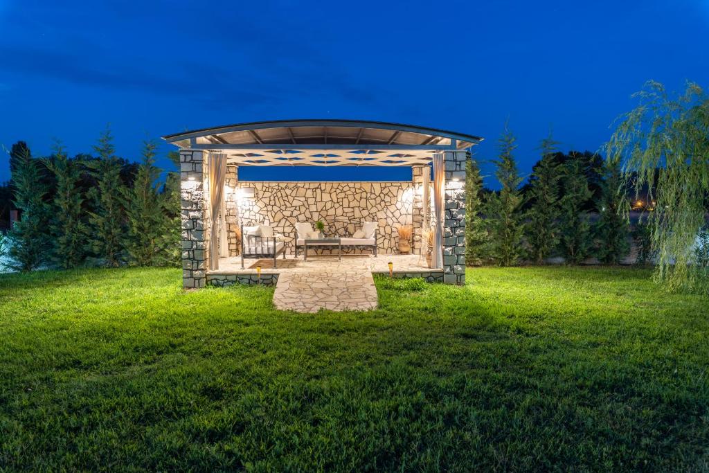 a gazebo in the middle of a lawn at A Ponte Studios & Apartments in Sykia Chalkidikis