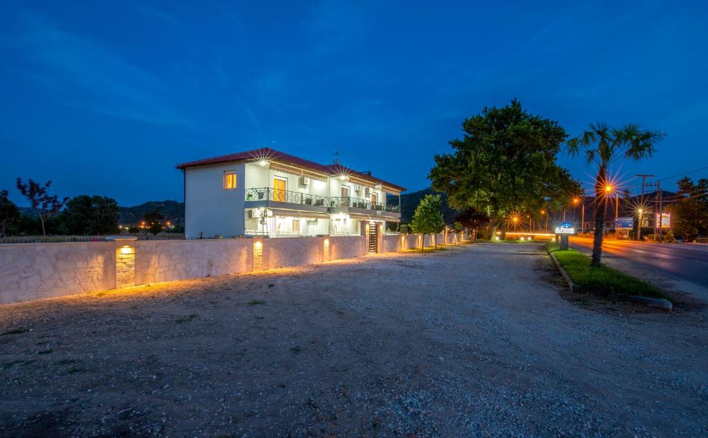 a house on a street at night at A Ponte Studios & Apartments in Sykia Chalkidikis