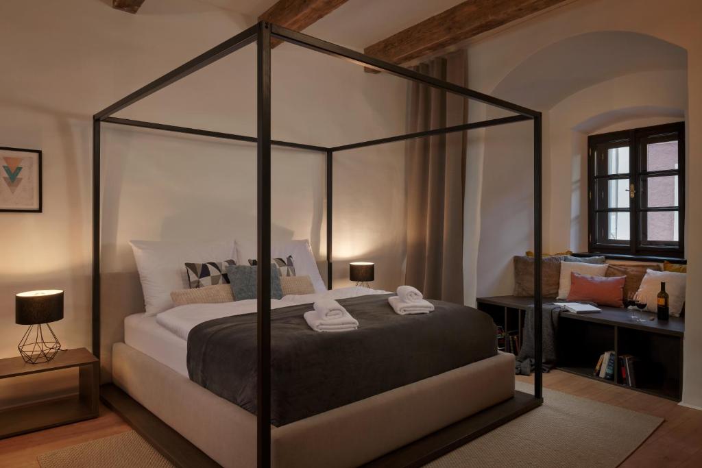a bedroom with a large bed and a large window at Pension Kristian in Český Krumlov