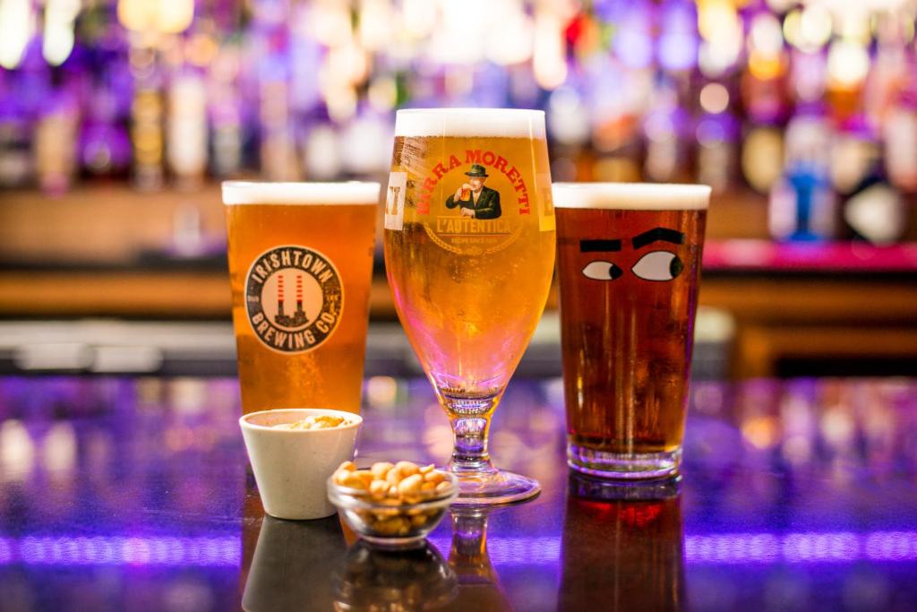 three glasses of beer sitting on a bar at Osprey Hotel in Naas