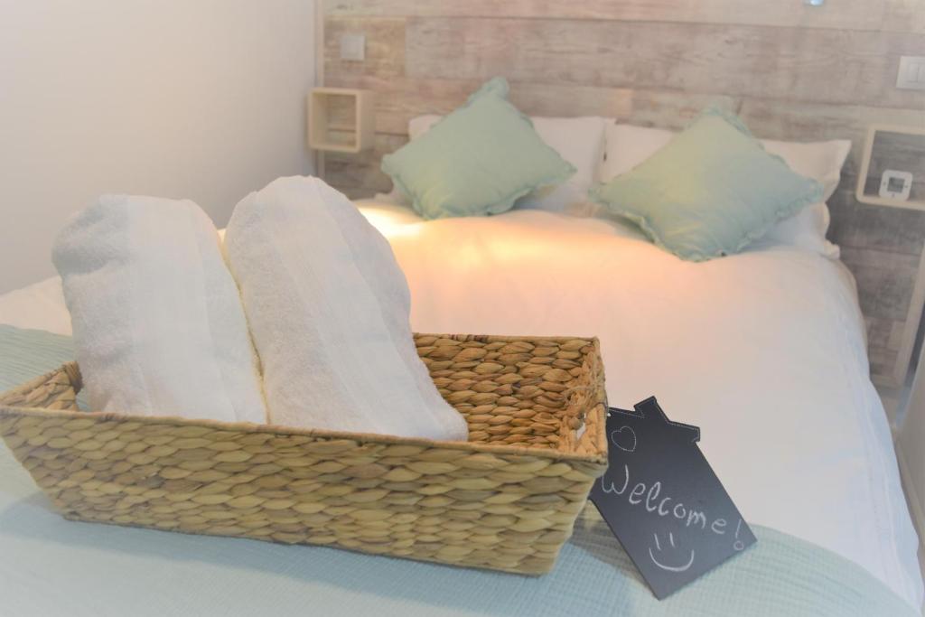 a basket on a bed with towels and pillows at Aloha G.C. in Las Palmas de Gran Canaria