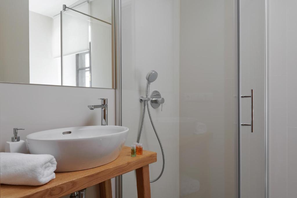 a bathroom with a white sink and a shower at Pension Kristian by KH in Český Krumlov