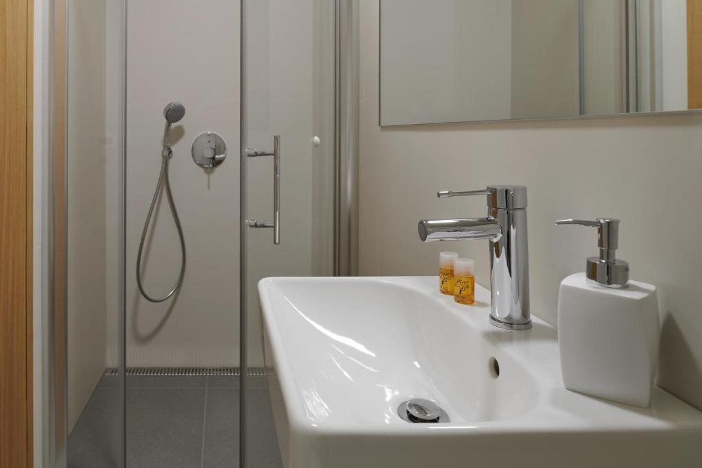 a bathroom with a sink and a shower at Pension Kristian by KH in Český Krumlov