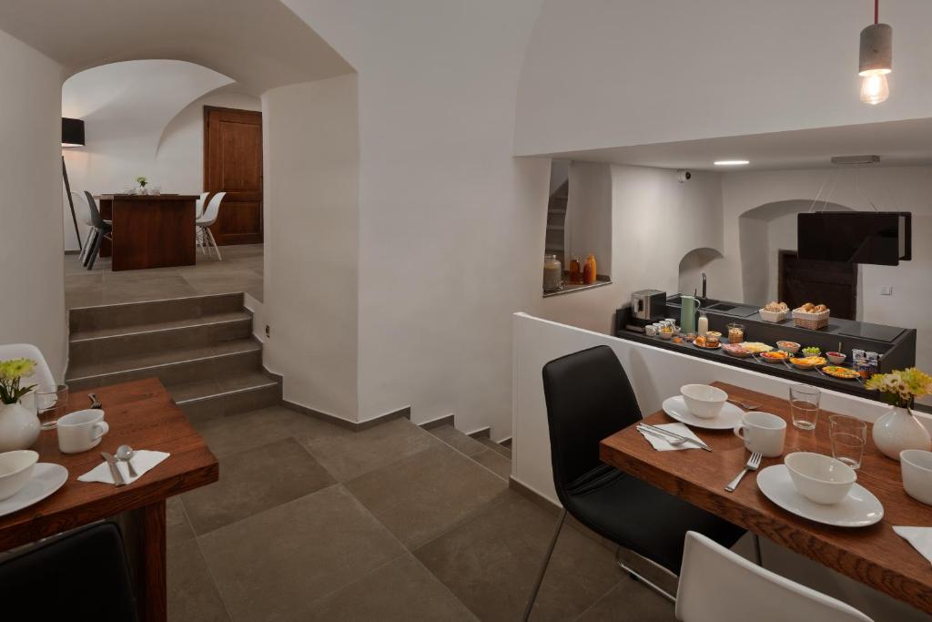 a dining room and kitchen with a table and chairs at Pension Kristian by KH in Český Krumlov