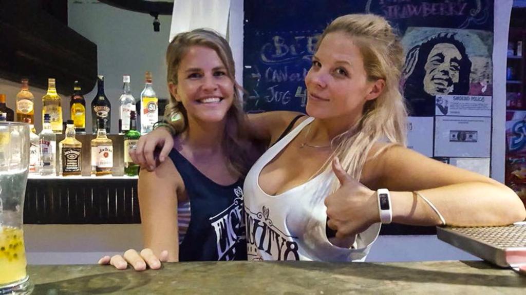 two women sitting at a bar giving a thumbs up at The Eighty8 in Phnom Penh