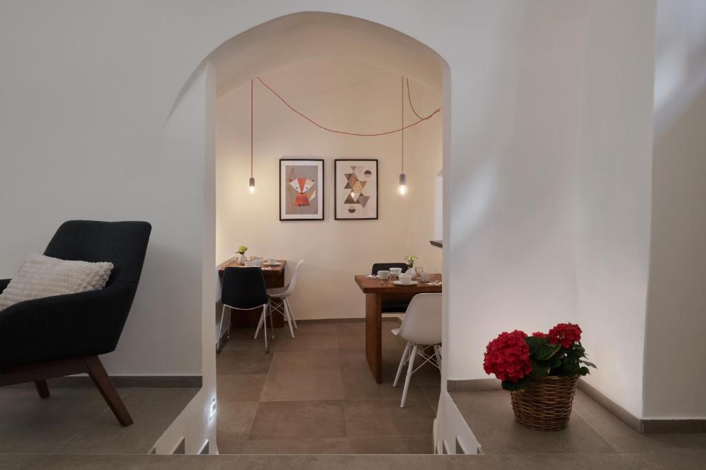 a living room with a table and a chair at Pension Kristian by KH in Český Krumlov