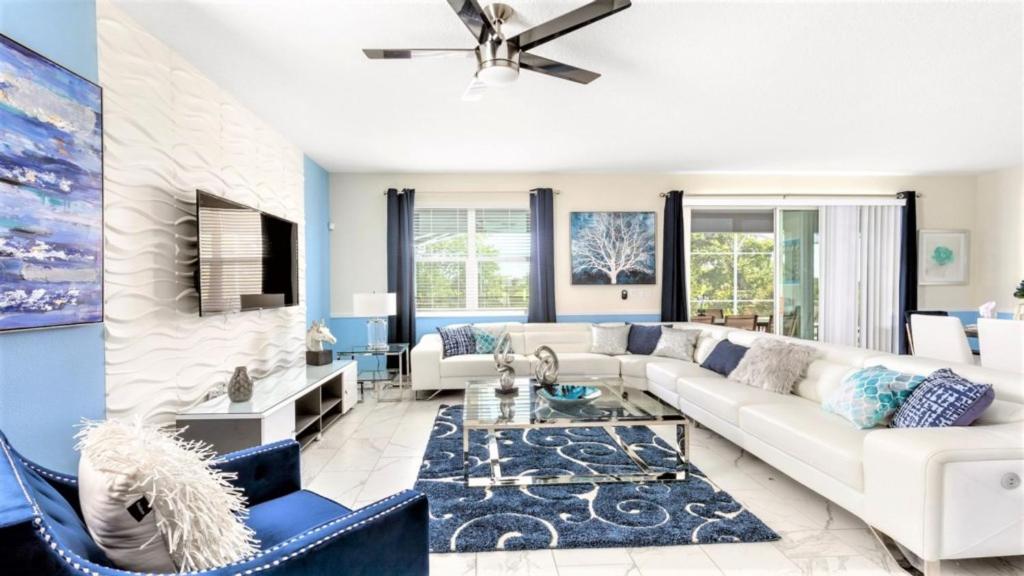 a living room with a white couch and blue walls at Luxury Pool Villa with Green View-8843IC’ in Davenport