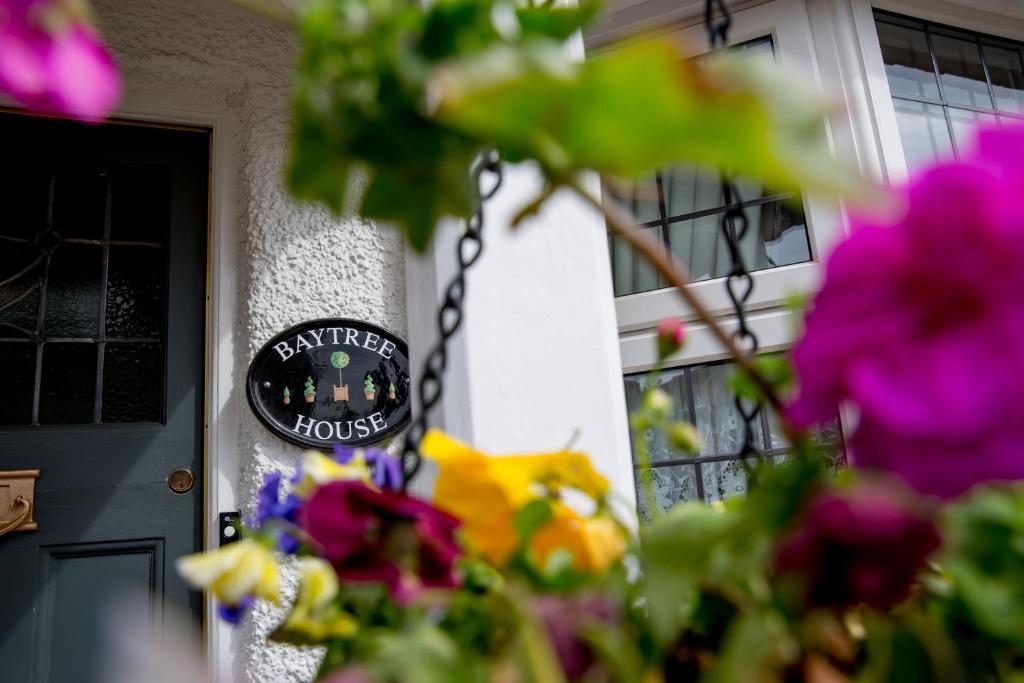 a front door of a house with a sign on it at Bay Tree House Bed & Breakfast in Barnet