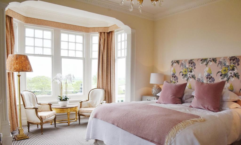 a bedroom with a bed and a large window at The Lookout Rye in Rye