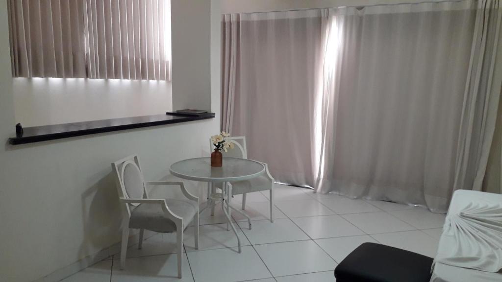 a white room with a table and chairs in it at Hotel Monte Rei in Salvador