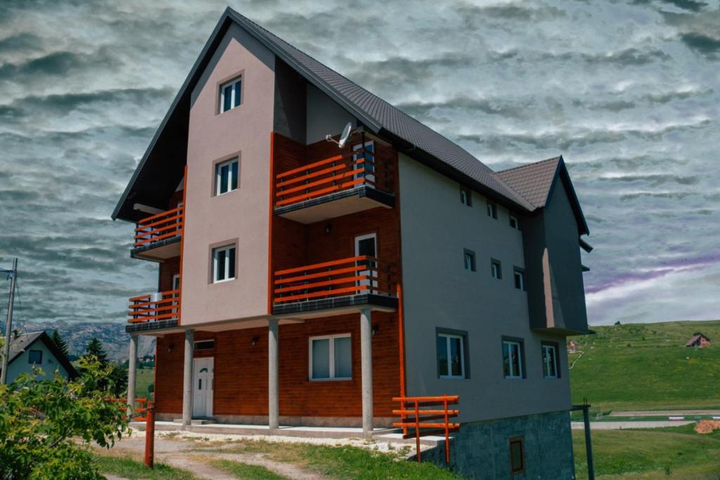 a building with balconies on the side of it at Apartmani Srećko in Žabljak