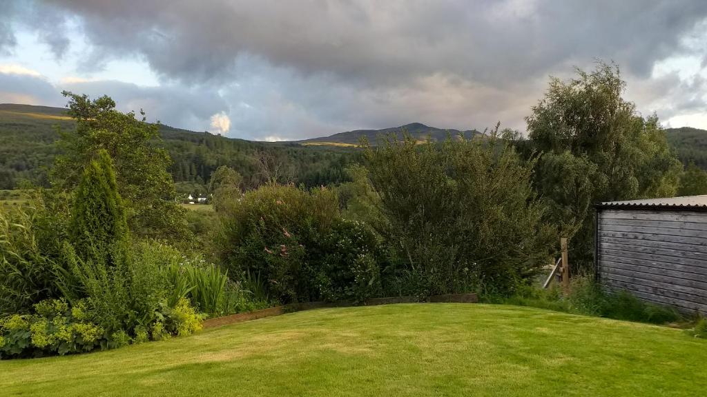 a view of a yard with a field of grass at The Studio in Drumnadrochit