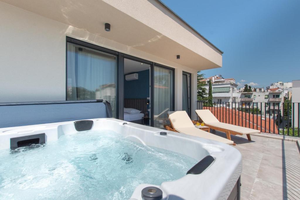 a hot tub on the balcony of a house at Seven Seas Residence in Split