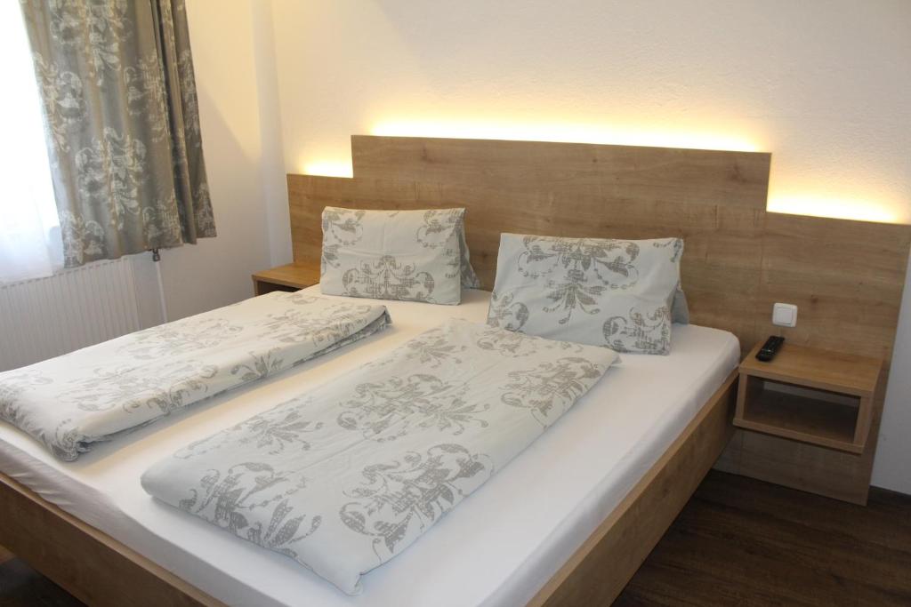 a bedroom with two beds with white blankets and pillows at Arrahof in Harmannschlag
