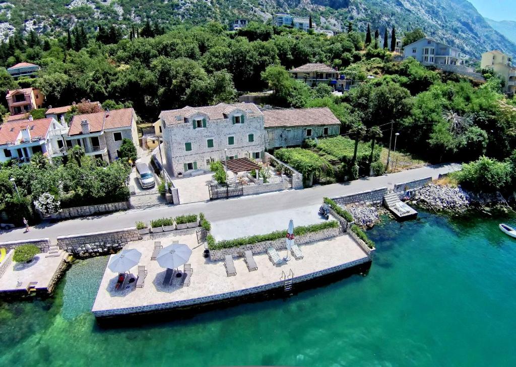 an aerial view of a house with a dock in the water at Vila Maestral Kotor in Kotor