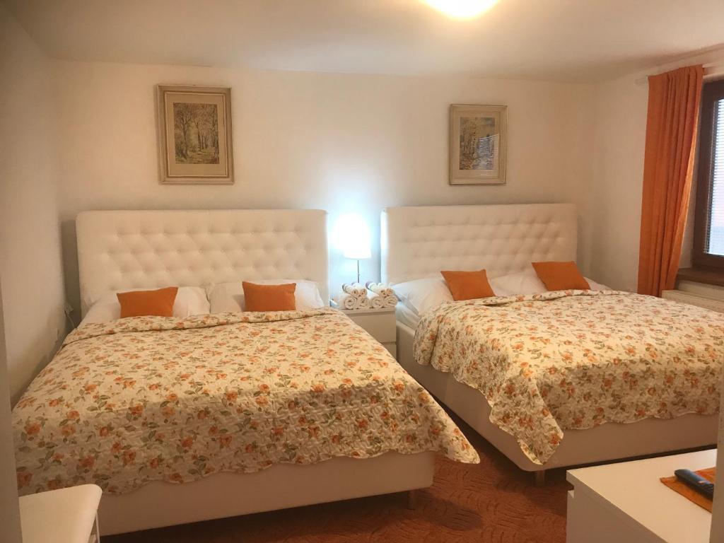 1 dormitorio con 2 camas y mesa con lámpara en Apartment pod Lysou, en Frýdlant nad Ostravicí