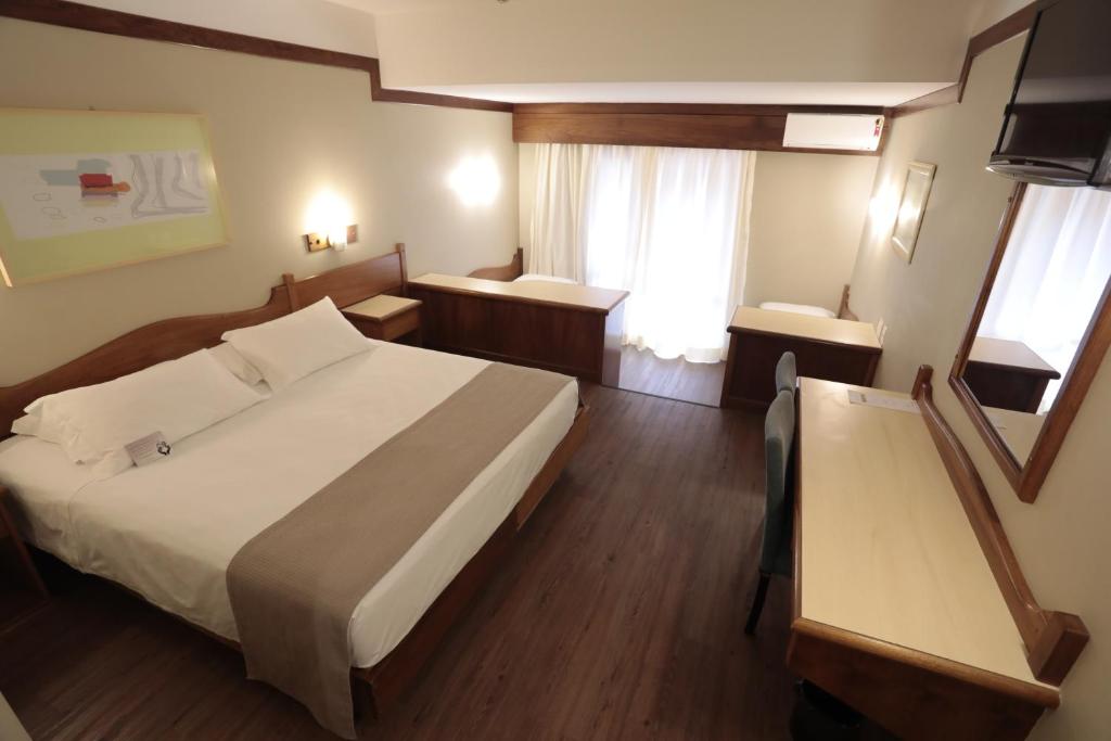 Postel nebo postele na pokoji v ubytování Tri Hotel