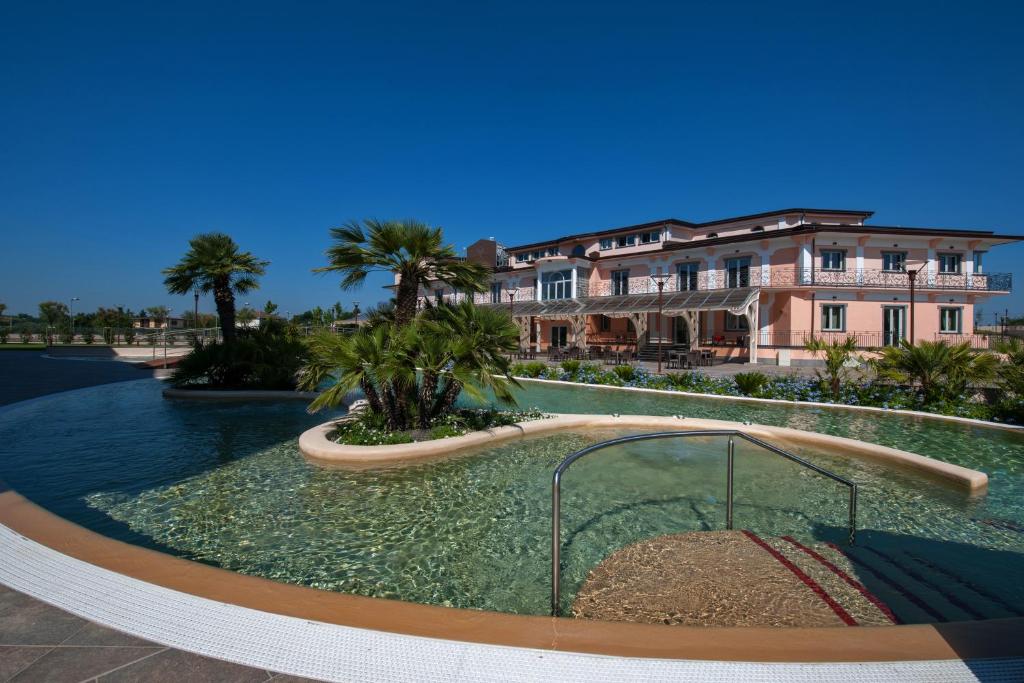 a swimming pool in front of a building at L' Araba Fenice Hotel & Resort in Altavilla Silentina